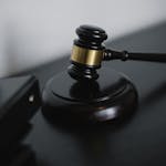 Close-up of a wooden gavel on a desk, symbolizing justice and legal authority.